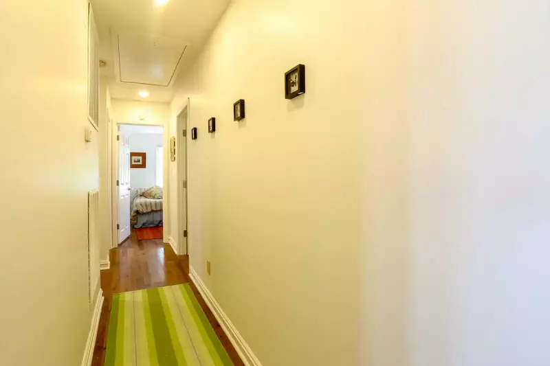 There is a hallway off the entrway area that leads to three of the home's bedrooms.