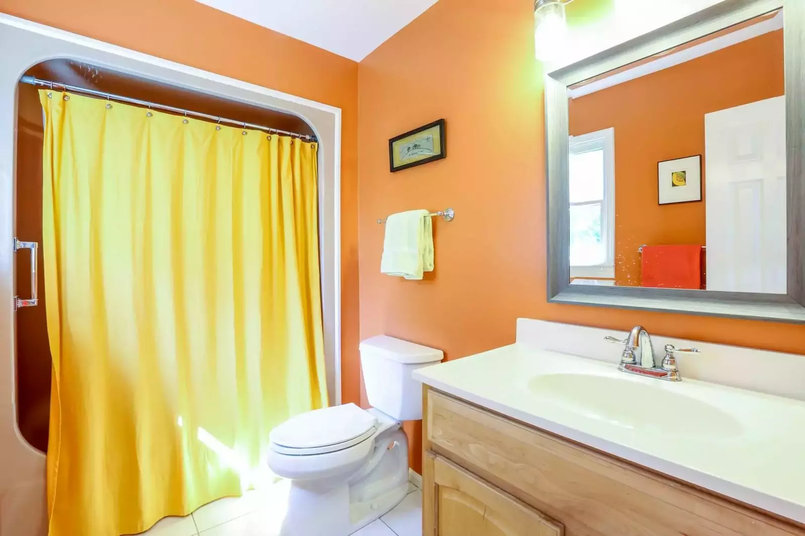 The en suite bathroom in the master suite has a large vanity, tiled floor and combined shower & tub.
