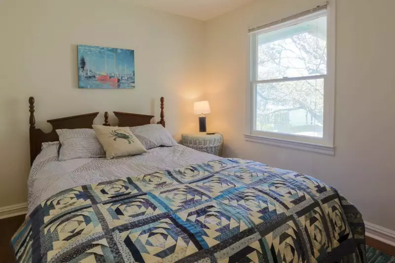 The queen guest bedroom overlooks the front of the house and E. Ashley Avenue.