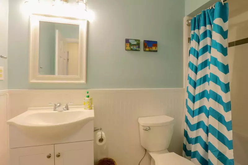 This bathroom, which is located off the hallway near 2 guest bedrooms, has a combined tub & shower.