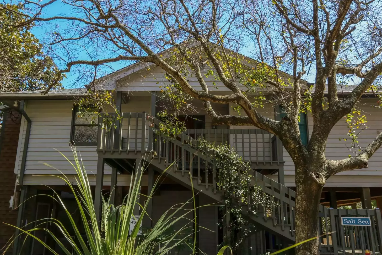 Guests access the front door of Salt Sea by climbing these exterior stairs to the front porch.