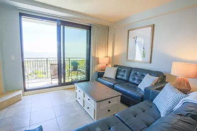 The sliding glass door in the living room opens out onto a private balcony.