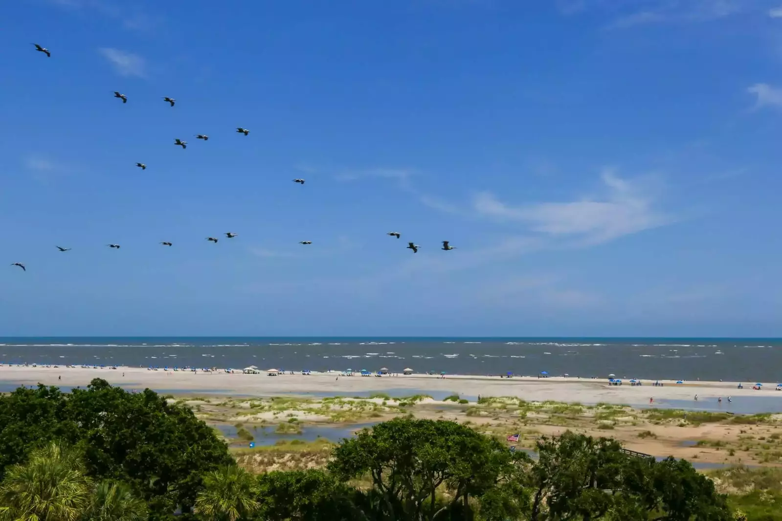 Come relax with the sights & sounds of the soaring pelicans, flying flags and crashing waves.