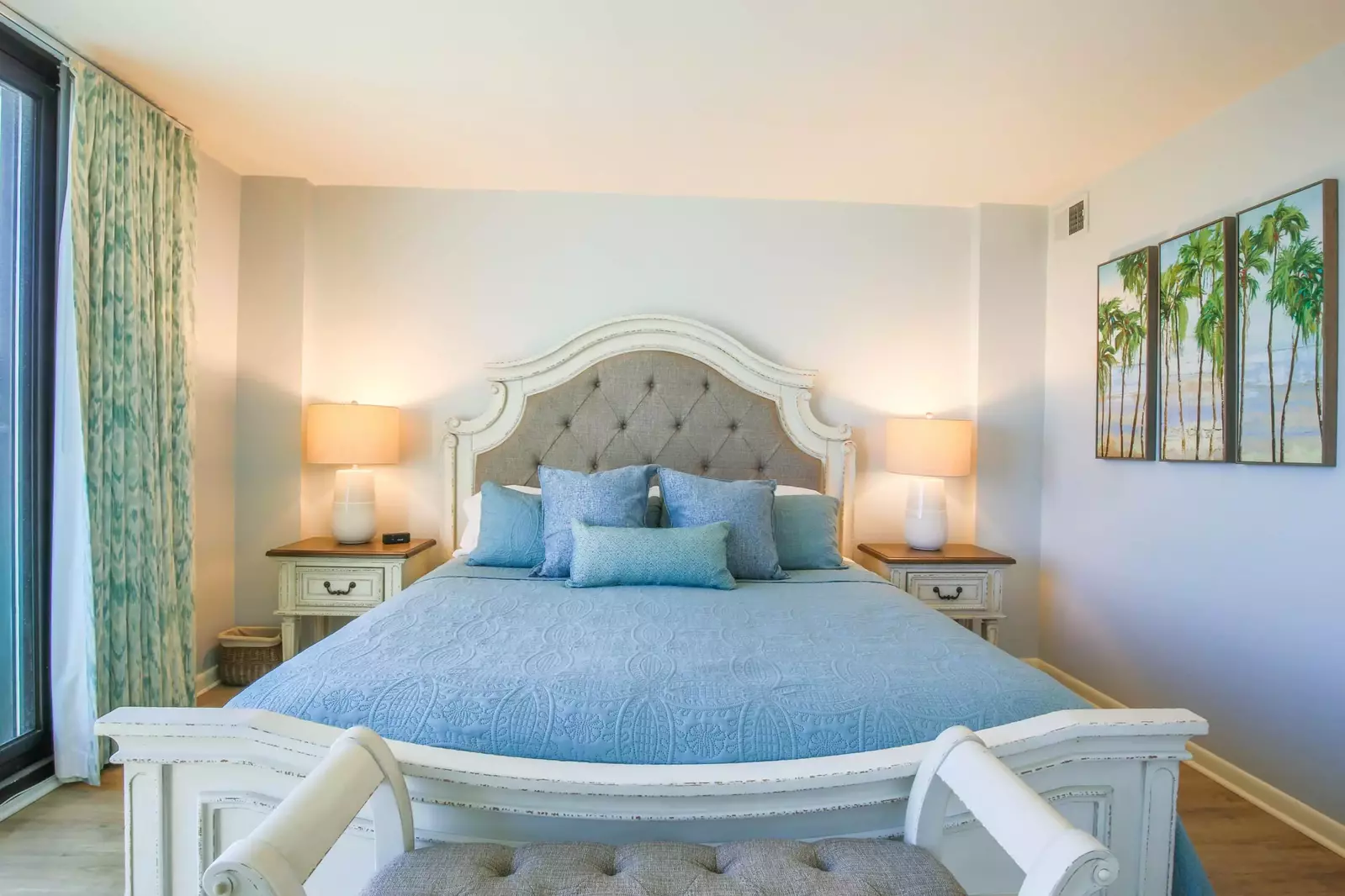 The king bed in the master suite has two night stands with reading lamps.