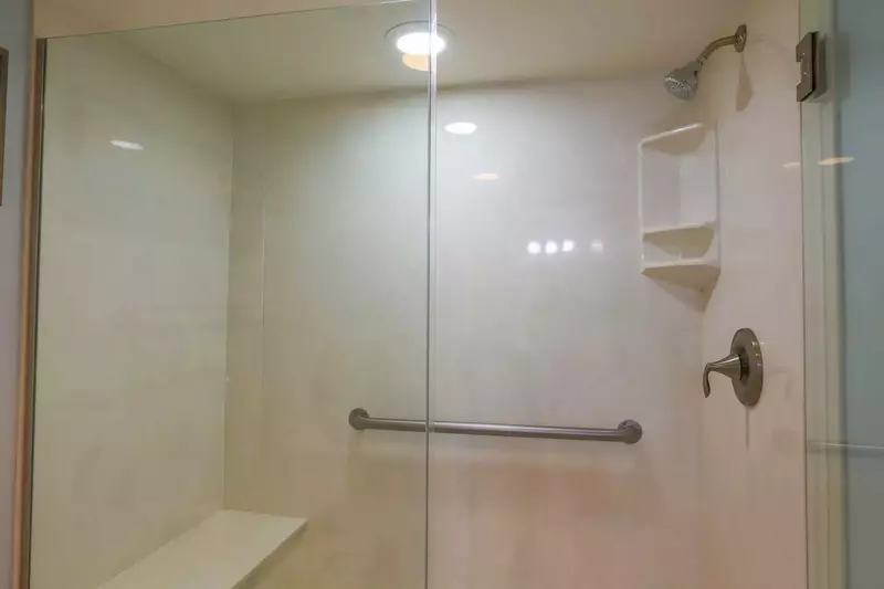 The en suite bathroom features a walk-in shower.