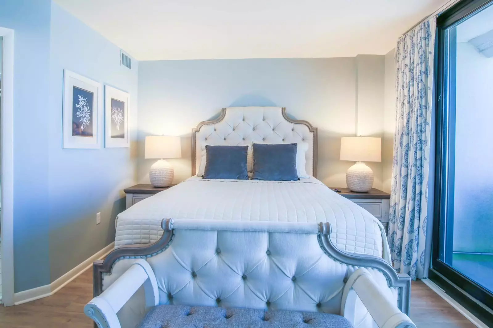 This guest bedroom also features hardwood floors and an en suite bathroom.
