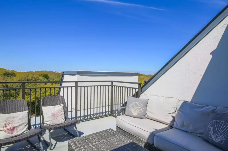 Step out from the upper level guest bedroom onto this spacious roof deck.