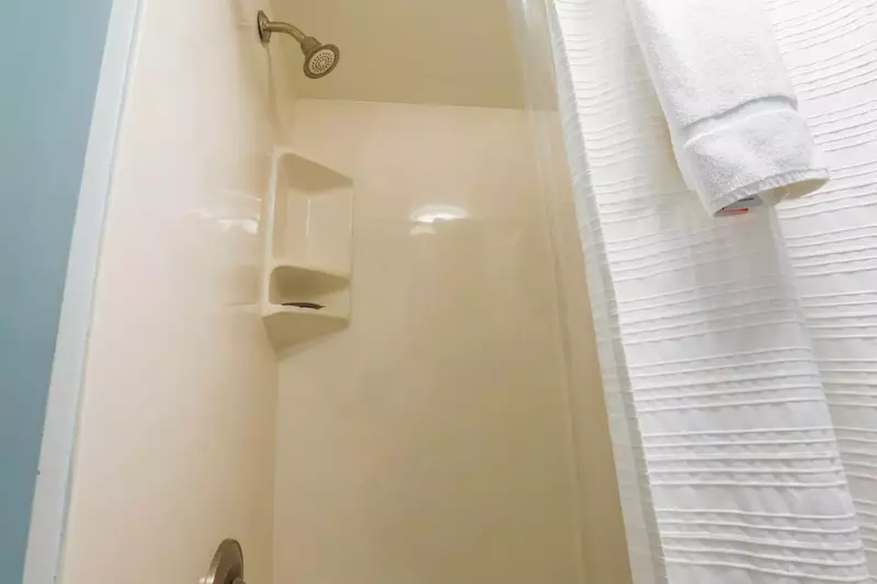 The bathroom on the lower level of the penthouse condo features a shower/tub combo.