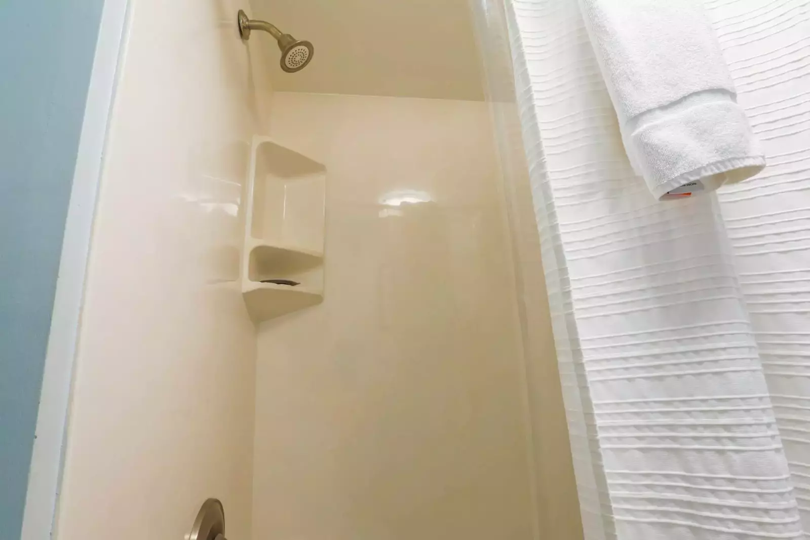 The bathroom on the lower level of the penthouse condo features a shower/tub combo.
