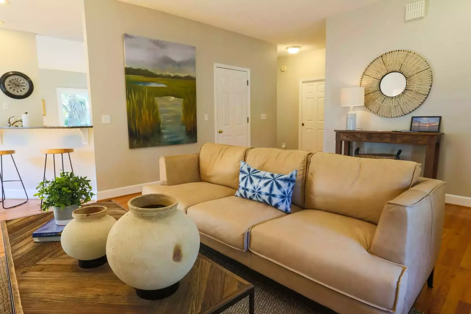 The small hallway behind the couch leads to two of the home's guest bedrooms.