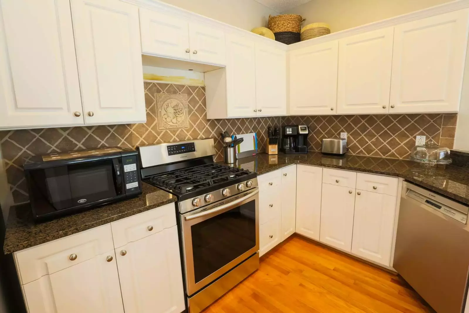 The kitchen features brand new stainless steel appliances.