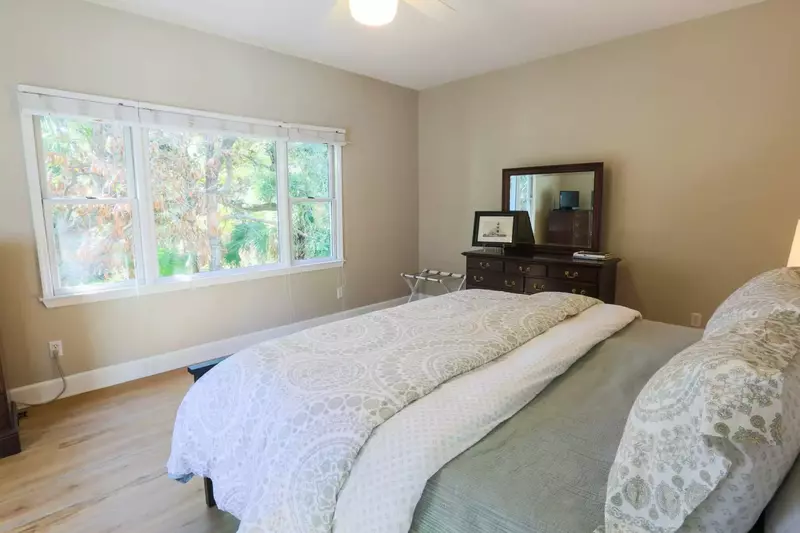 The master bedroom enjoys peaceful views of the trees behind the house.