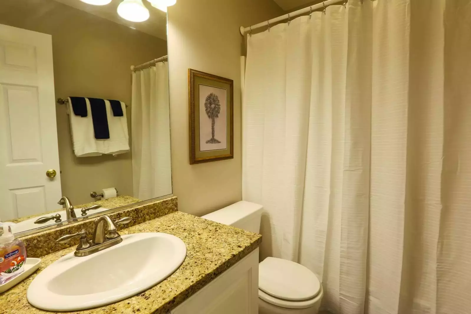 The second floor bathroom features a shower/tub combo and granite topped vanity.