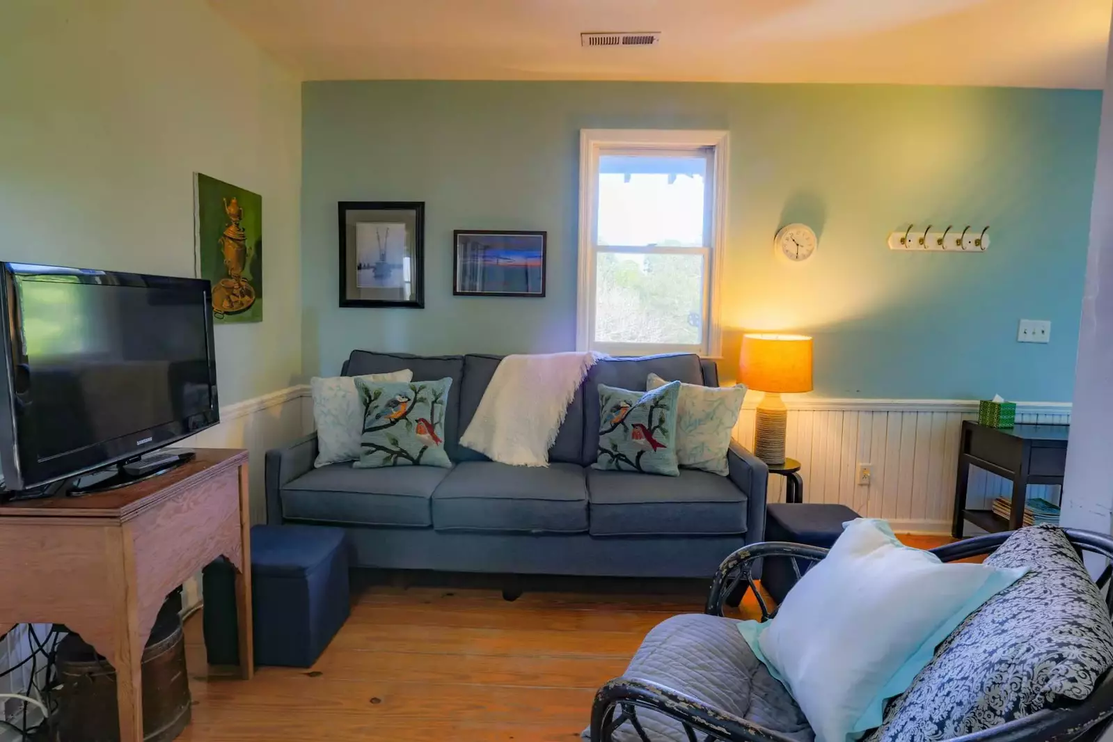 Although this traditional island home is meant for outdoor living there's a cute seating area complete with new sofa and smart TV!