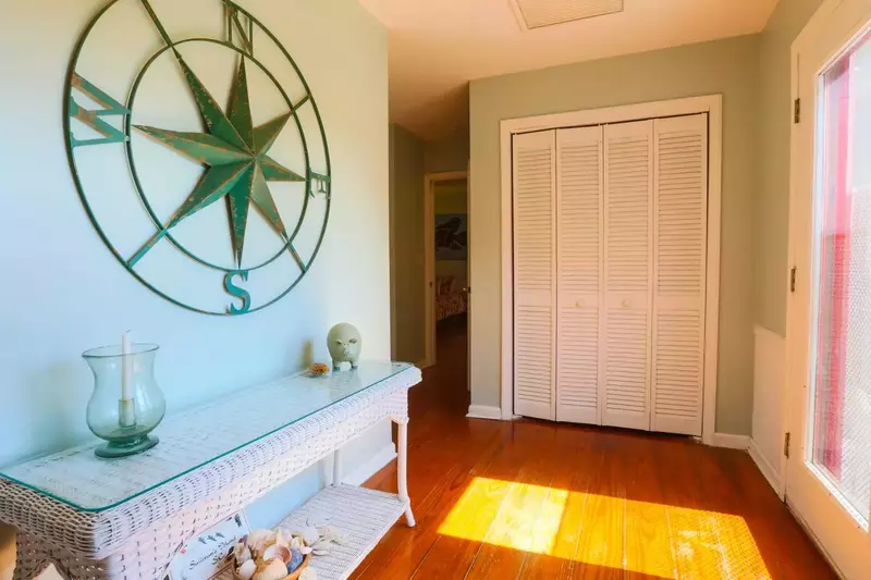 If you enter the front door and turn right, you'll find a hallway that leads to 2 bedrooms and 2 bathrooms.