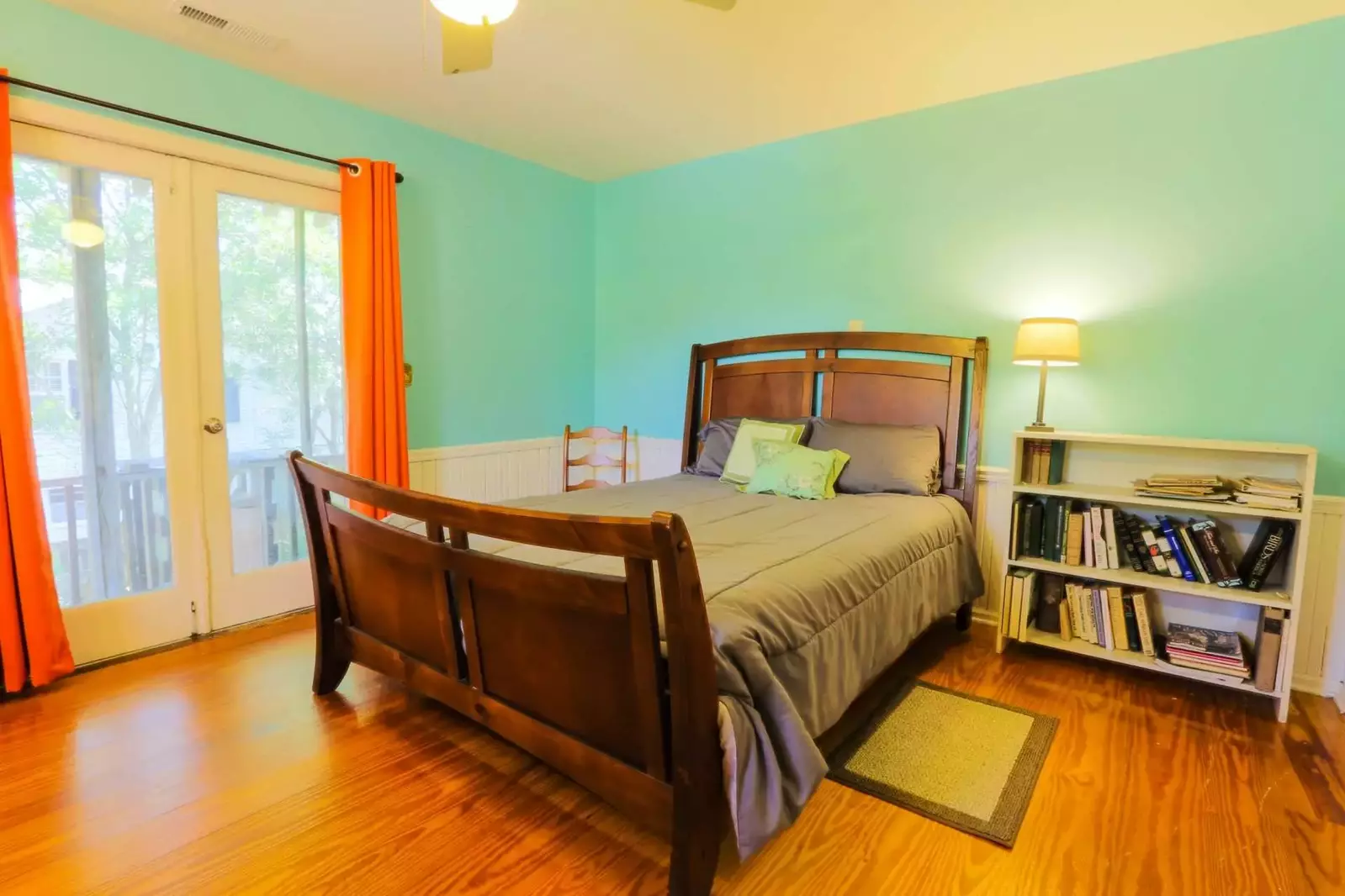 This bedroom has a queen bed, hardwood floors, ceiling fan and French door access to the screened-in porch.