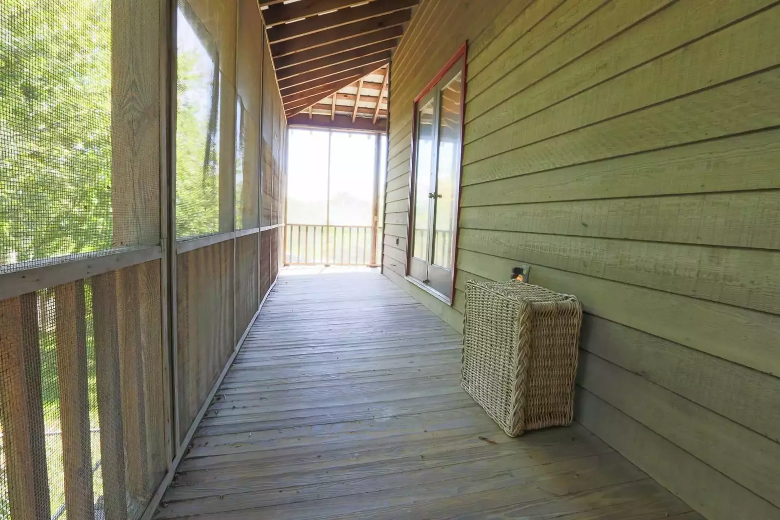 This screened-in porch runs along the bedroom side of the house.