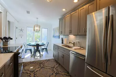 The kitchen features a refrigerator, dishwasher, garbage disposal, stove, microwave & more!