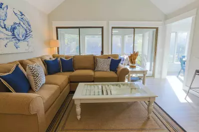 The living room also offers sliding door access to the villa's sundrenched screened porch.