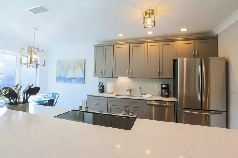 This beautiful, newly renovated kitchen features custom cabinets, marble countertops and stainless steel appliances.