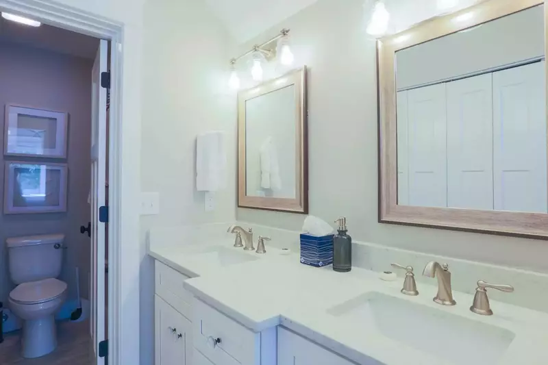 The master bathroom has a double sink vanity with ample cabinet & countertop storage areas.
