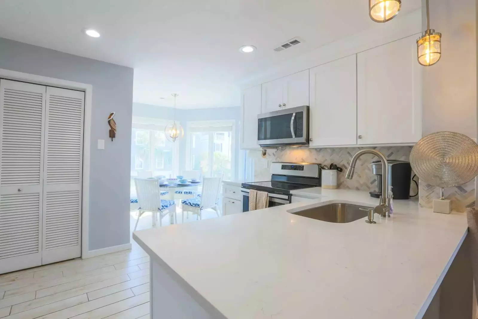 The dining table, which is surrounded by windows, is located just off the newly renovated kitchen.