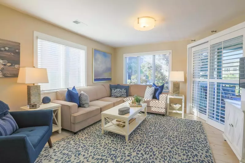 The living room boasts ocean views and sliding door access to the screened porch.