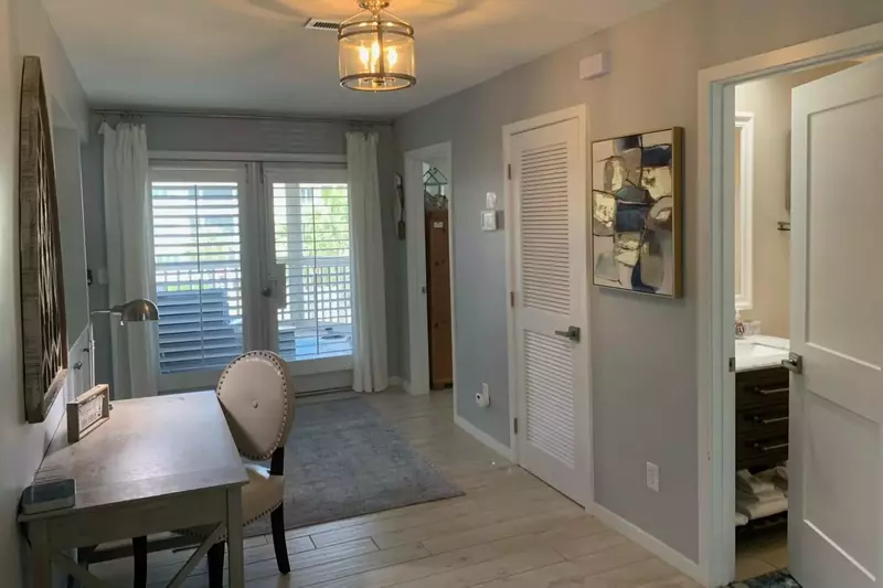 The double doors at the end of the hallway take you out onto the screened porch.