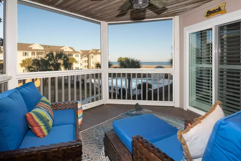 The screened porch features comfy seating and pillows to help you relax and take in the ocean views.