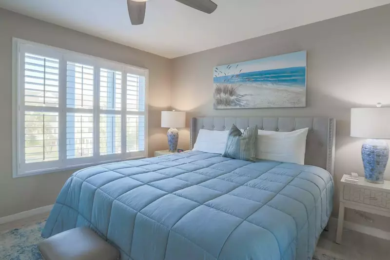 The master bedroom overlooks the community pool and beach.