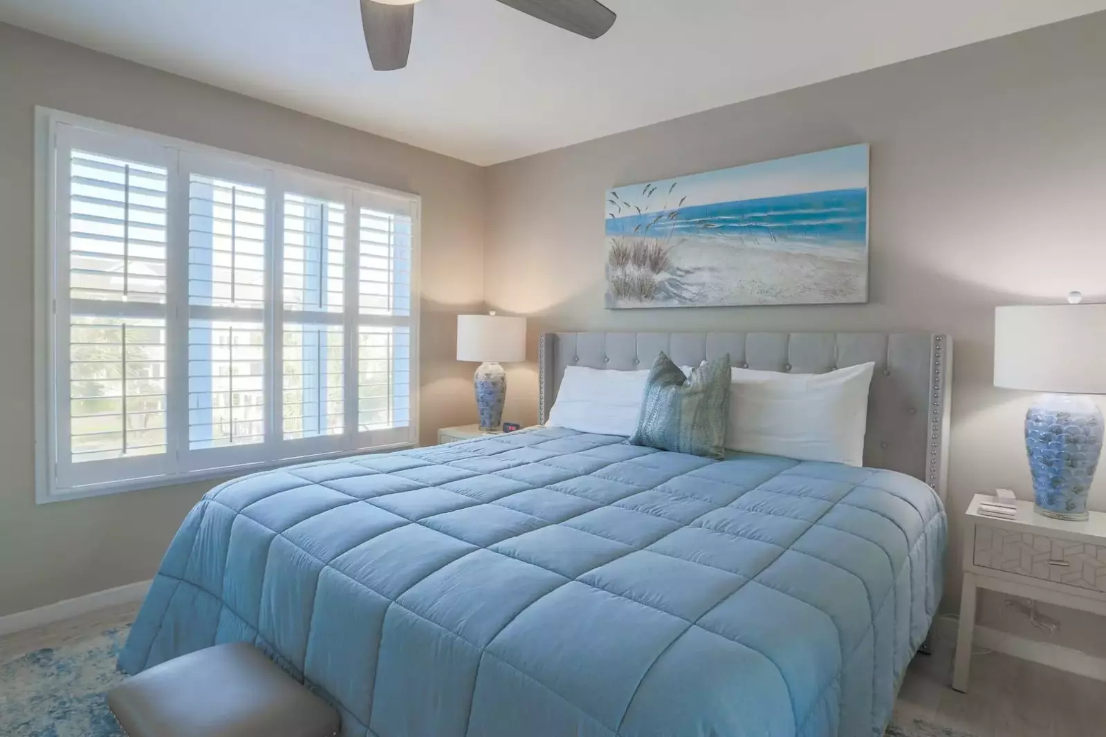The master bedroom overlooks the community pool and beach.