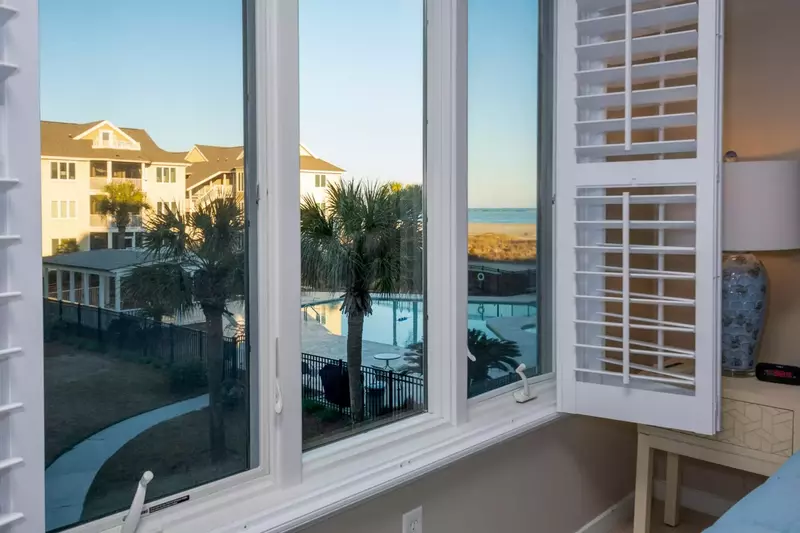 The master bedroom gets terrific views of the community pool & beach.