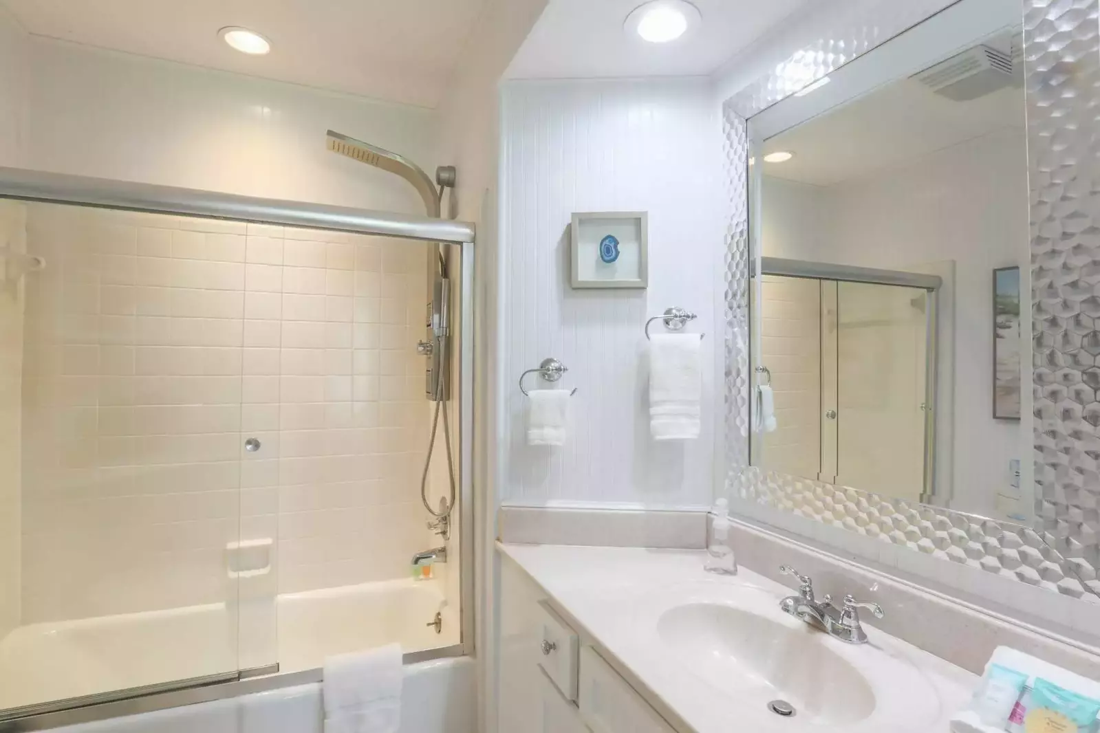 The master bathroom also has a vanity with undercounter storage, hairdryer and corner shelves.