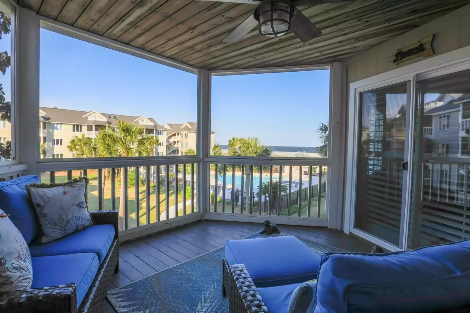 The screened porch features comfy seating and pillows to help you relax and take in the ocean views.