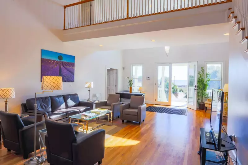 The home's four bedrooms are located on the front side of the house to the left & right of this central room.