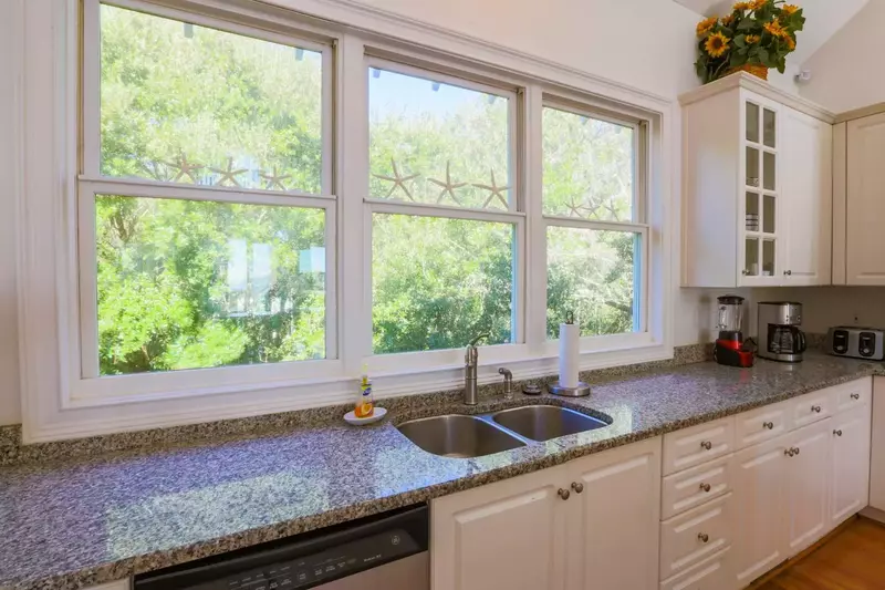 The kitchen windows overlook the tree tops in the back yard.