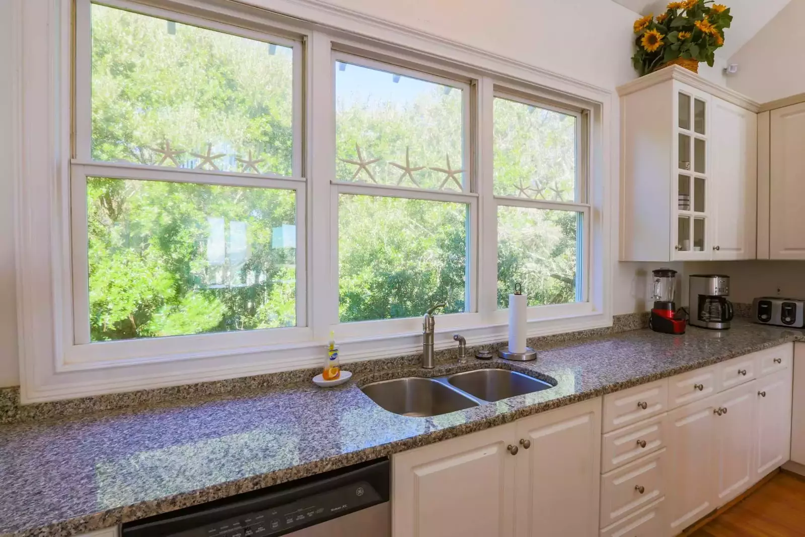 The kitchen windows overlook the tree tops in the back yard.