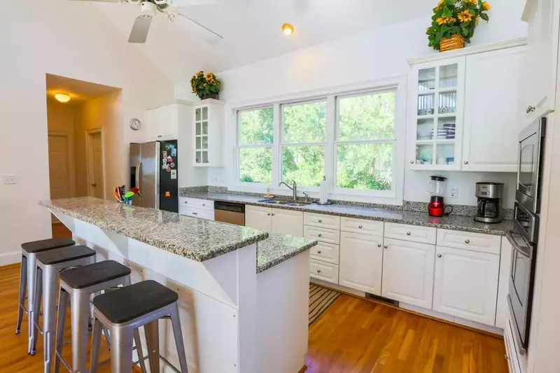 There is a half bathroom, laundry room and elevator down the hallway off the kitchen.