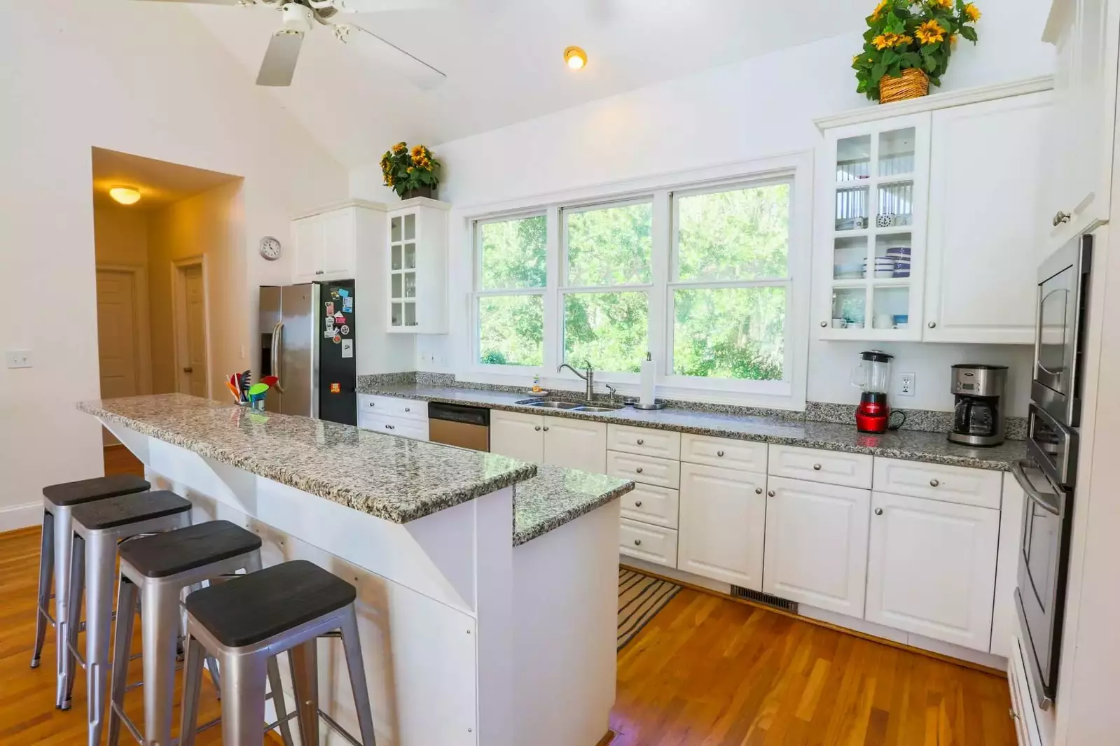 There is a half bathroom, laundry room and elevator down the hallway off the kitchen.