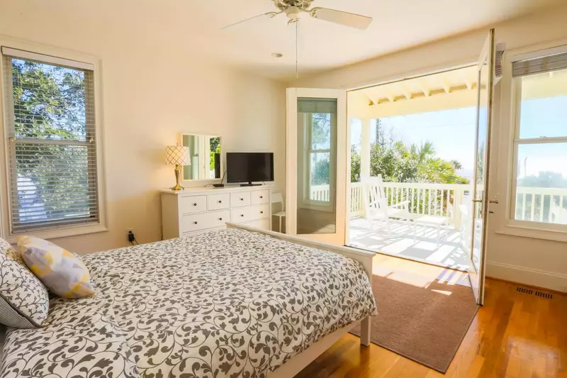 This bedroom features ocean views, hardwood floors and access to the front porch.