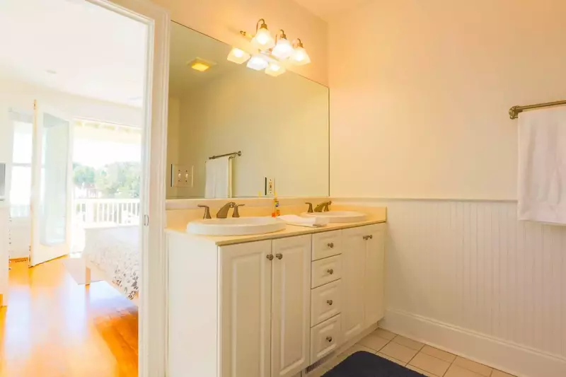 This bathroom also features a double sink vanity with cabinet & drawer storage for your bathroom items.