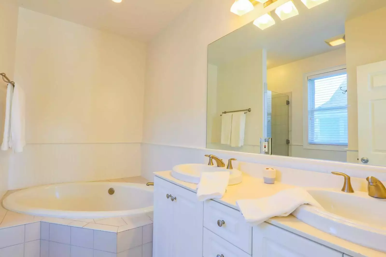The master bedroom also has an en suite bathroom with a soaking tub and double sink vanity.