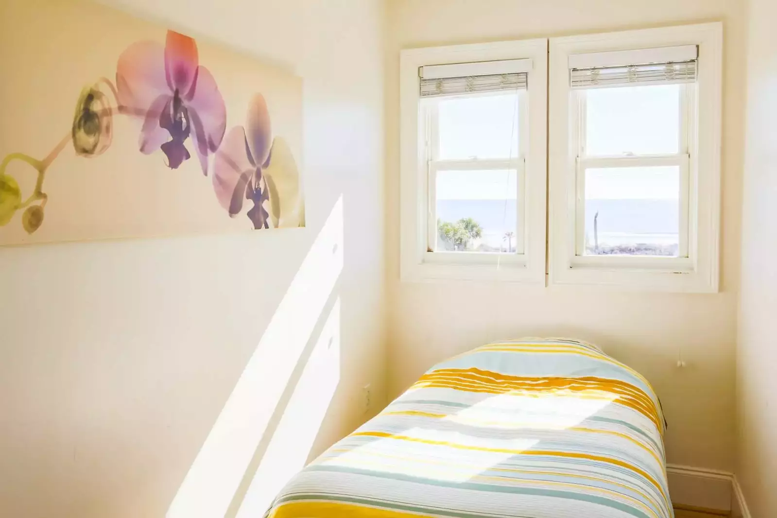 The third twin bed is tucked away near these windows with ocean views.
