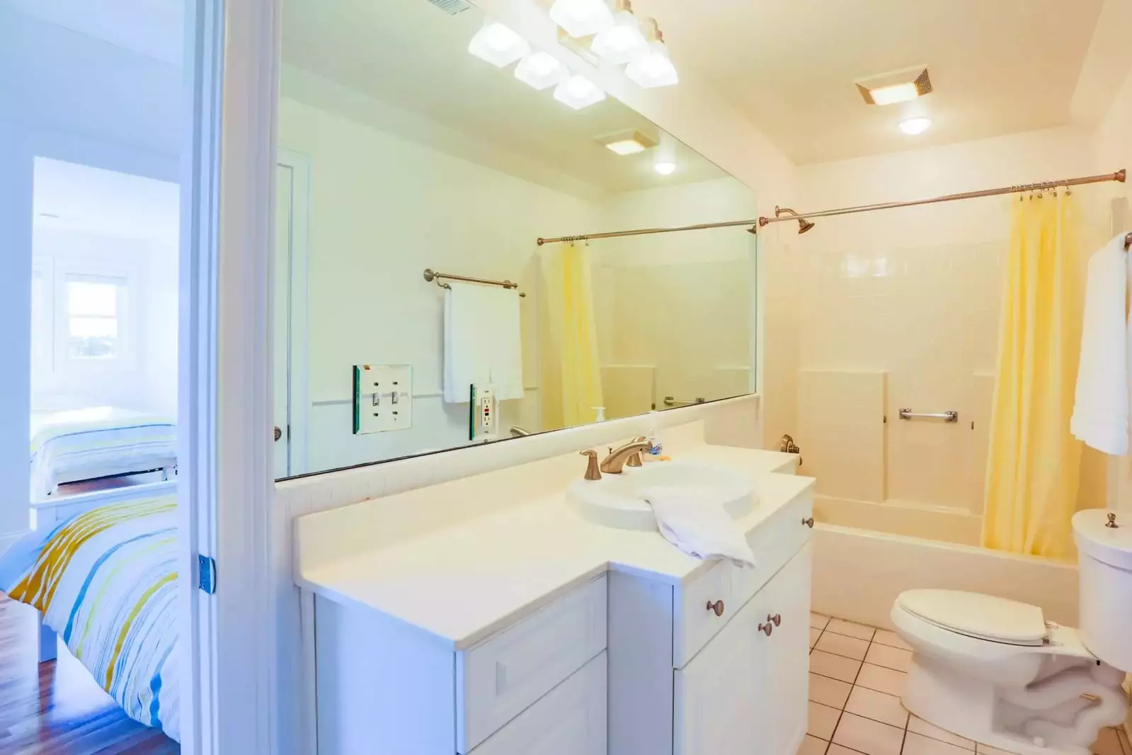 The en suite bathroom features a tiled shower/tub combo and a vanity with plenty of storage space for your personal items.