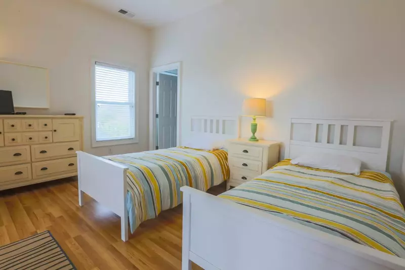 This bedroom has lovely bright light and bright comforters!