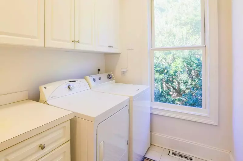 The laundry room is located near the kitchen and features a full-sized washing maching and dryer.