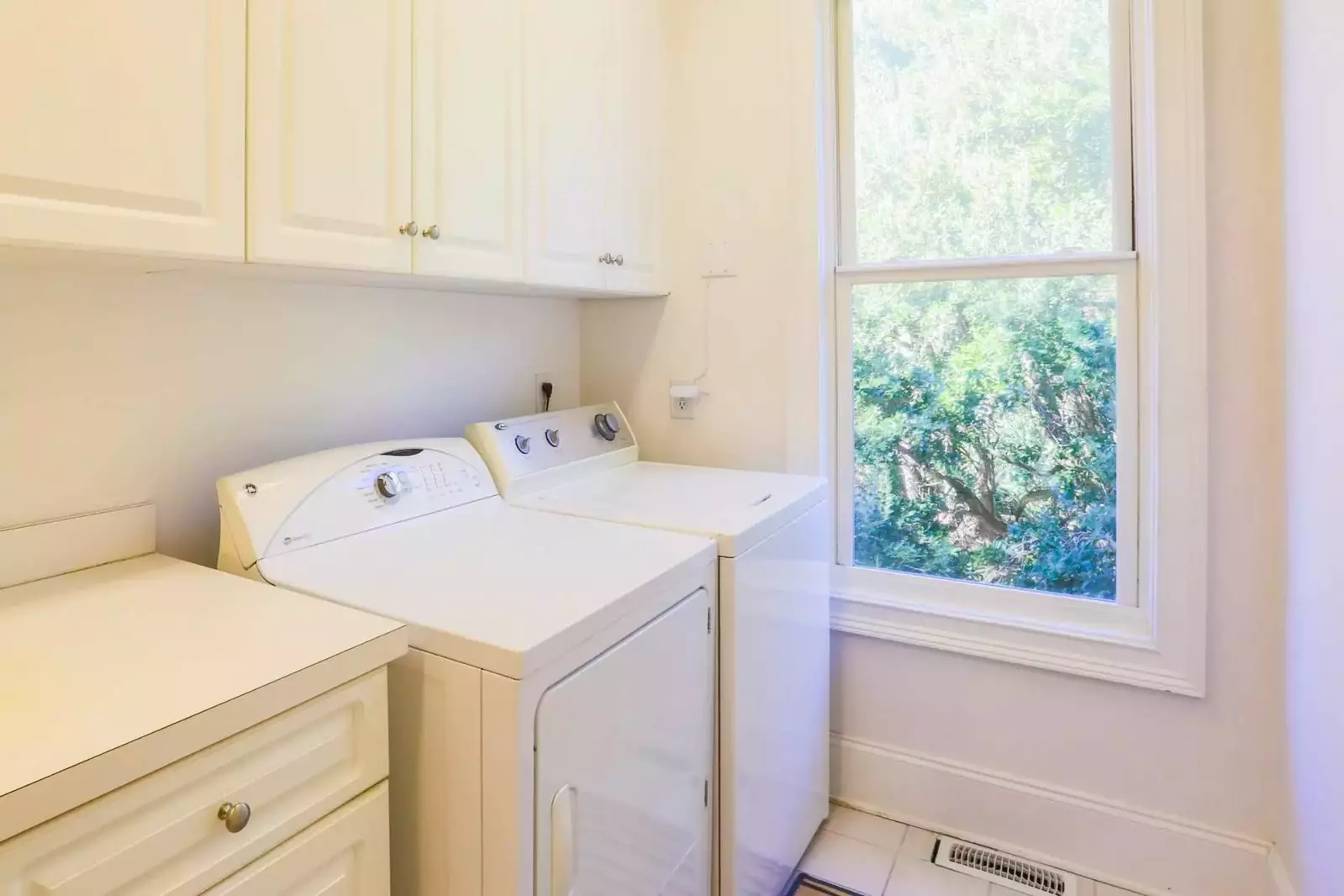 The laundry room is located near the kitchen and features a full-sized washing maching and dryer.