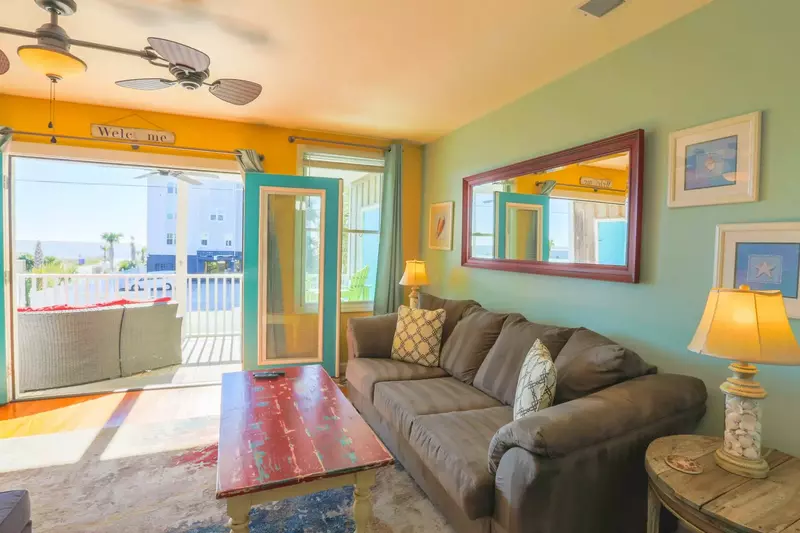 The condo is decorated with fun colors & comfortable furniture.