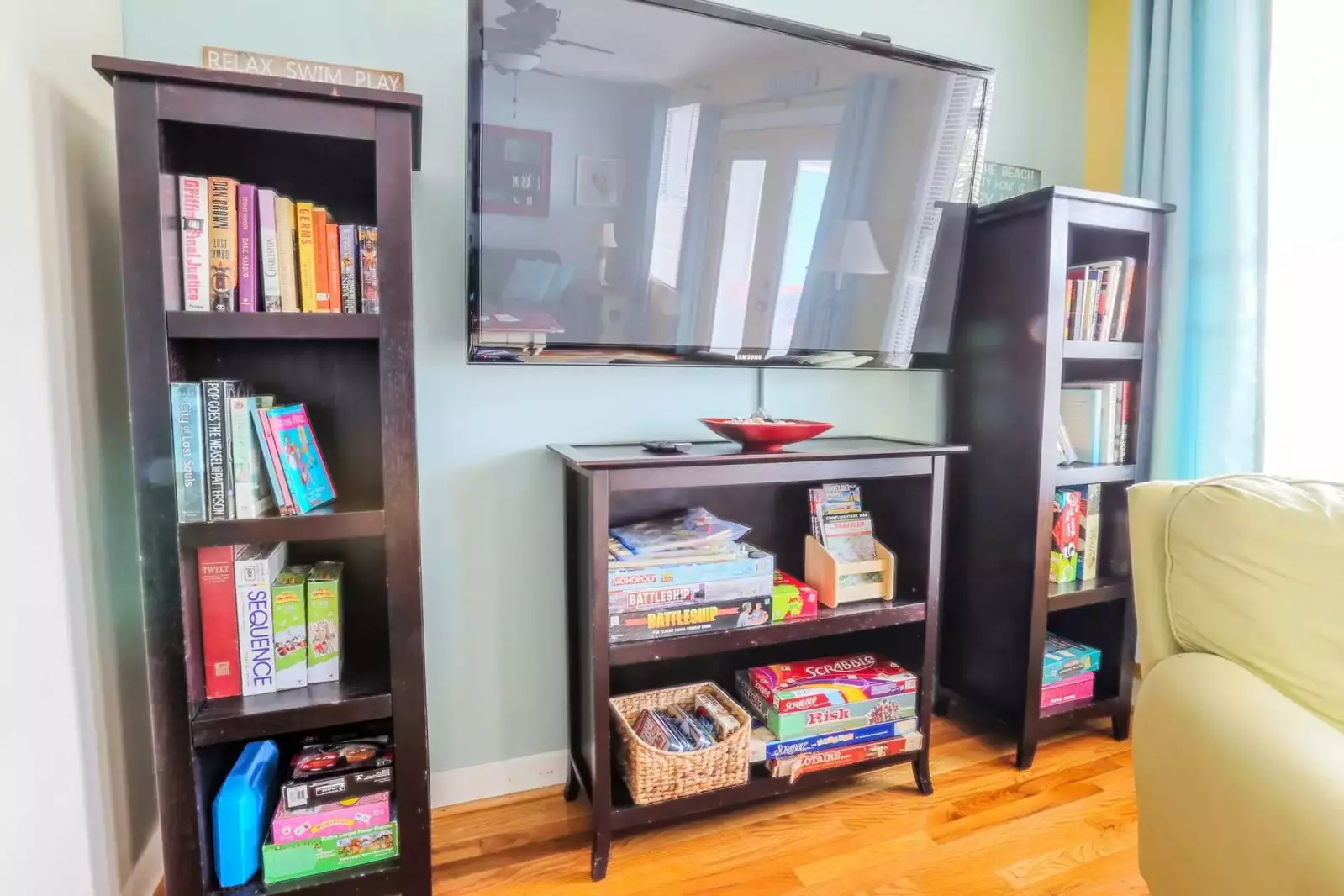 There's a large screen, wall mounted smart TV in the living room.