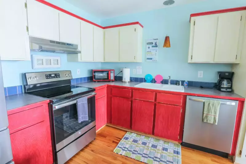 The kitchen features a stainless steel refrigerator, dishwasher and range.